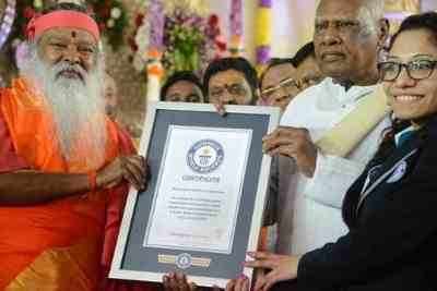 (From left to right) Ganapathy Sachchidananda along with the Governor of the State of Tamilnadu, India accepting the Guinness certificate from Guinness World Record Representative, Ms. Fortuna Burke.