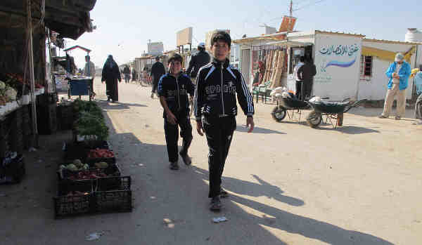 Syrian refugee children walking on a street in the Za’atari camp in northern Jordan. Photo: UNICEF/Simon Ingram