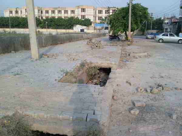 Risky pits right in the middle of the road near a government school.
