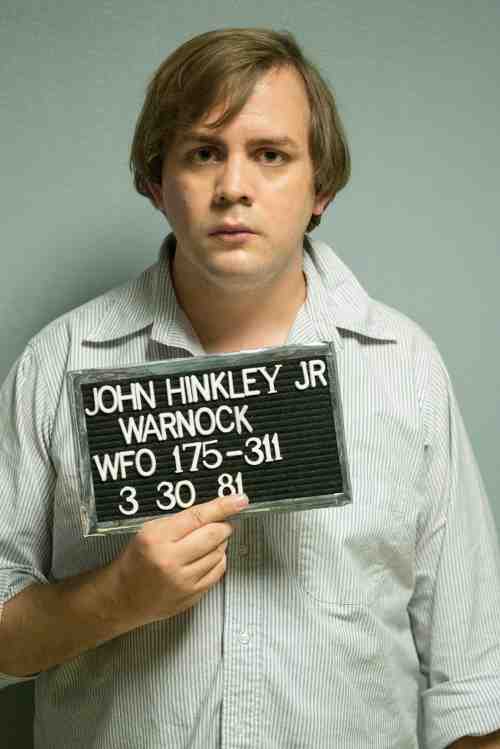 Kyle More portraying John Hinckley Jr after his attempted Presidential assassination.