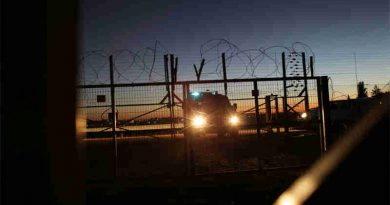 An Israeli Security Forces vehicle lights a gate in the security fence that separates farmers in the Biddu enclave from their land in the Seam Zone, which is the land between the 1949 Armistices Line and the West Bank Barrier. UN Photo: Alaa Ghosheh / UNRWA Archives