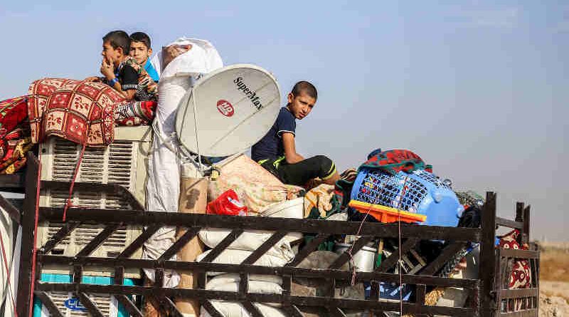 On 01 November children sit in the back of a truck loaded with their belongings on their way back home in Anbar Governorate, Iraq