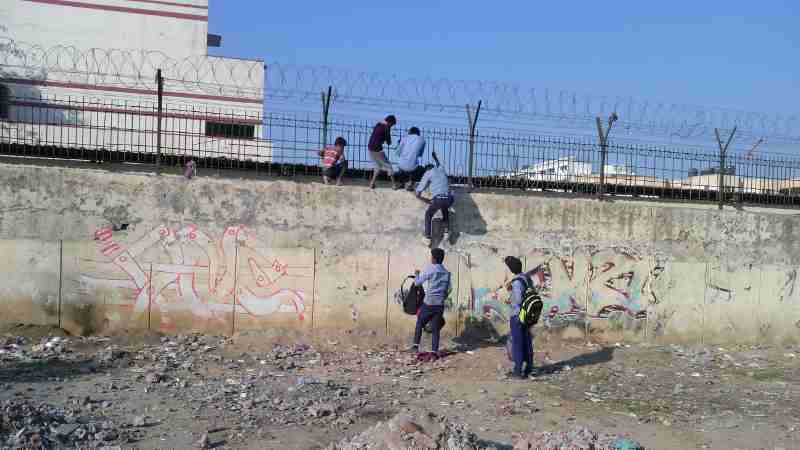 Students of a government school in Delhi cross high walls and barbed wires to abscond from the school. Teachers have no control on students.  Click the photo to read the full report. Photo by Rakesh Raman