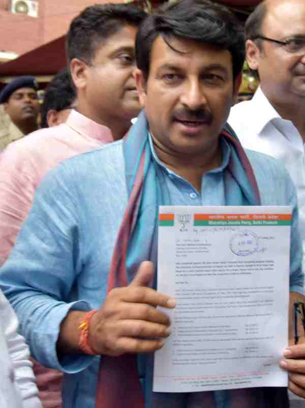 BJP leader showing complaint letter regarding irregularities in the donation records of AAP.