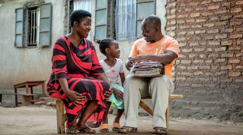 Seven-year-old Vera Edna (centre) sits with her father Edward (right) and her mother Annette in Kasese, western Uganda, Saturday 25 March 2017. Photo: UNICEF
