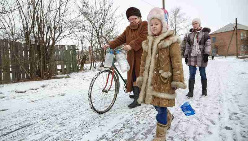 On 13 February 2017, Nina (left) and her granddaughters, Diana (right), 14, and Sasha (center), 6, leave their home in Ukraine to collect water from the well located on the outskirts of the village. Photo: UNICEF (file photo)