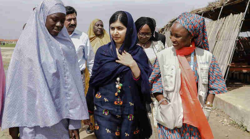 On 18 July 2017 in Maiduguri, Malala Yousafzai (center) is shown around the school in Bakassi camp by student, Fatima Grema (left) who has been displaced by the conflict in northeast Nigeria. During her visit to Nigeria, education activist Malala Yousafzai met with girls displaced by the Boko Haram crisis.