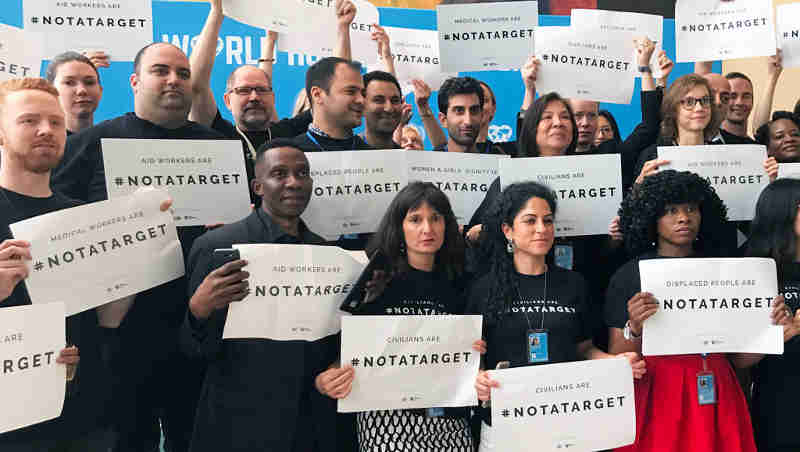 Staff stand together at United Nations Headquarters in New York to draw attention that civilians are #NotATarget. Photo: UN News/Paulina Carvajal