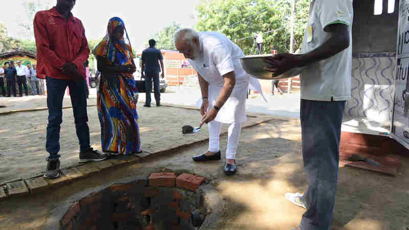 Narendra Modi doing shramdan for the construction of a twin pit toilet, at Village Shahanshahpur, Varanasi, Uttar Pradesh on September 23, 2017