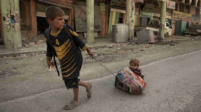 A boy pulls his sibling on a make-shift sledge outside the Old City after fleeing heavy fighting in Mosul, Iraq, Thursday 6 July 2017. Photo: UNICEF