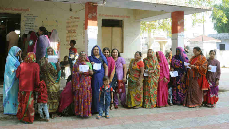 Voters waiting at a polling booth in India. Photo: PIB