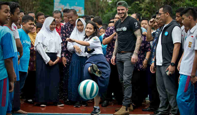 UNICEF Goodwill Ambassador David Beckham plays football with students and teachers at the SMPN 17 school in Semarang, Indonesia, March 27, 2018