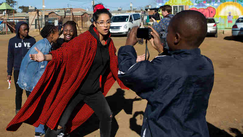 On 22 July 2018 in South Africa, (centre) UNICEF Goodwill Ambassador Lilly Singh interacts with a child during a visit to the Isibindi Safe Park in Soweto. Photo: UNICEF