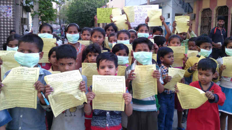 Children of RMN Foundation free schools distributing pamphlets during an environment protection campaign, urging the Delhi government to save them from pollution. But the careless government is not taking any steps to stop pollution. Campaign and photo by Rakesh Raman, founder of the humanitarian organization RMN Foundation.