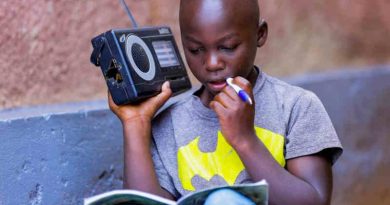 In Rwanda, a boy listens to a radio. Photo: UNICEF