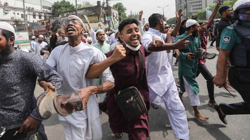 Protest against PM Modi’s visit outside Dhaka’s Baitul Mokarram mosque in March 2021. Demonstrators raised their shoes in their hands to register their anger against Modi. Photo: Mahmud Hossain Opu / Al Jazeera