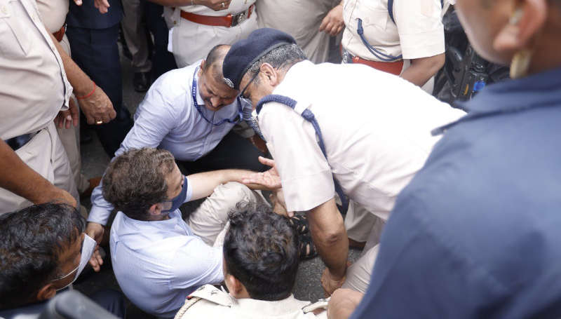 Congress leader Rahul Gandhi - surrounded by policemen - sitting on the road during a protest in New Delhi on July 26, 2022. Photo: Congress