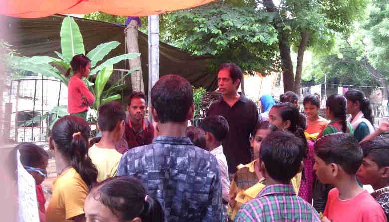 With the help of student volunteers, RMN Foundation founder Rakesh Raman explaining the benefits of modern alternative education to people in a street of Delhi. (Representational Image)