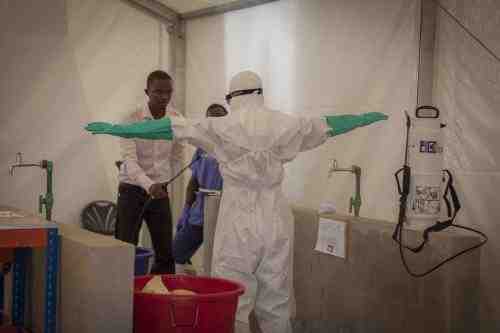 Prospective health-care workers in the Kerry Town Ebola Treatment Center test decontamination procedures in Sierra Leone. Photo by Louis Leeson / Save the Children.