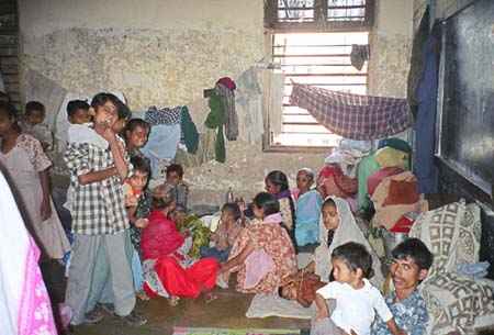 In the picture above: A room in the Dariyakhan Ghummat relief camp in Ahmedabad (Gujarat) housing over 50 women and children in 2002. The camp held 5,100 people and is one of approximately one hundred relief camps in Gujarat, where 98,000 people, a great majority of them Muslim, have been displaced by the violence. Photo courtesy: Smita Narula / Human Rights Watch