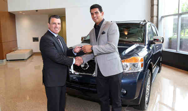 Tennessee Titans QB Marcus Mariota is presented the keys to a 2015 Nissan Armada by Fred Diaz, SVP, Nissan Sales and Marketing and Operations, USA, Tuesday, July 28, 2015, in Nashville, Tennessee, at Nissan North America headquarters.