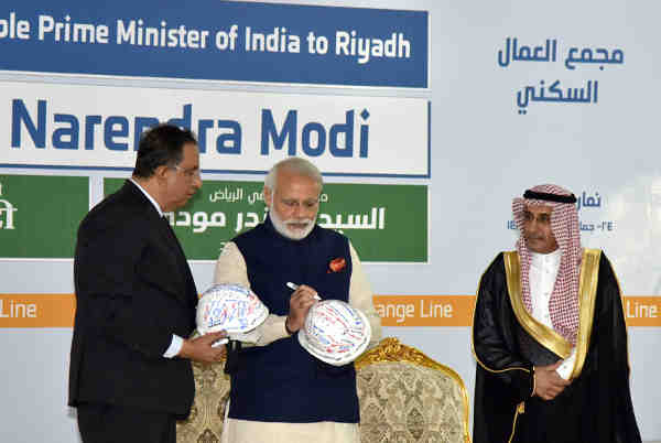 Narendra Modi signing the helmet, during his visit to the L&T residential complex, in Riyadh, Saudi Arabia on April 02, 2016