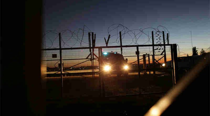 An Israeli Security Forces vehicle lights a gate in the security fence that separates farmers in the Biddu enclave from their land in the Seam Zone, which is the land between the 1949 Armistices Line and the West Bank Barrier. UN Photo: Alaa Ghosheh / UNRWA Archives