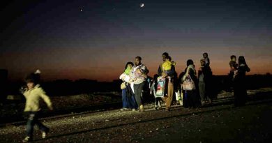 Iraqi civilians, who fled fighting in the city of Mosul, walk lit up by Iraqi special forces armoured vehicles, as they head to camps housing displaced people on November 2, 2016 in Bazwaia, Iraq. Photo: UNICEF