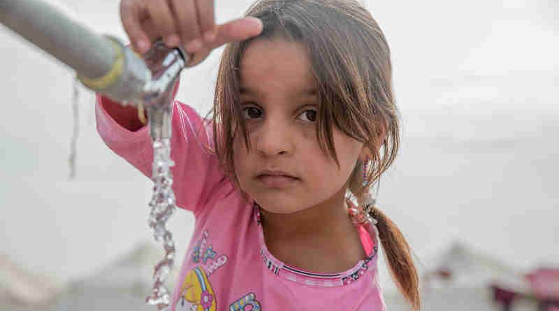 A young girl from Mosul takes water from a tap stand at a UNICEF-supported Temporary Learning Space in Hassan Sham Displacement Camp, Ninewa Governorate. Photo: UNICEF (Representational image)