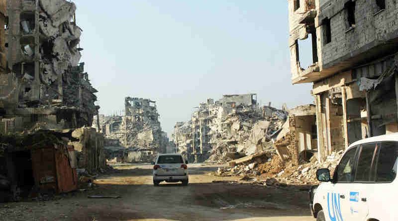 UN vehicles travel along a road lined with remnants of destroyed buildings, Homs, Syria. (file) Photo: UNICEF / UNI178367/ Tiku (file photo)