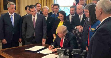 President Donald Trump, center, signs the NASA Transition Authorization Act of 2017