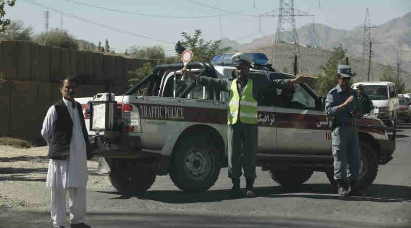 An Afghan traffic policeman controls a traffic jam in Maidan Shar. Photo UNAMA / Fardin Waezi.