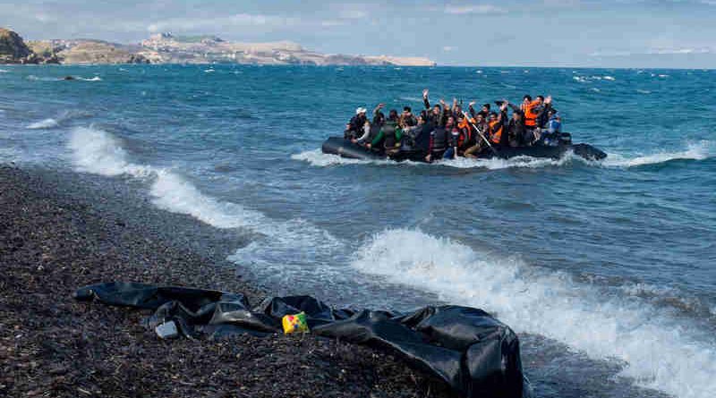 Newly arriving refugees wave and laugh as the large inflatable boat they are in approaches the shore, near the village of Skala Eressos, on the island of Lesbos, in the North Aegean region of Greece. Photo: UNICEF/Ashley Gilbertson VII