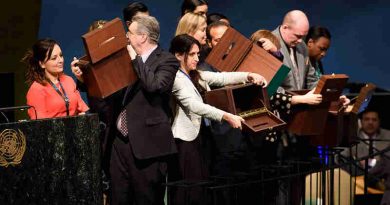 Conference officers hold up empty ballot boxes before collecting ballots from delegates. UN Photo/Manuel Elias