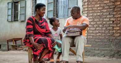 Seven-year-old Vera Edna (centre) sits with her father Edward (right) and her mother Annette in Kasese, western Uganda, Saturday 25 March 2017. Photo: UNICEF