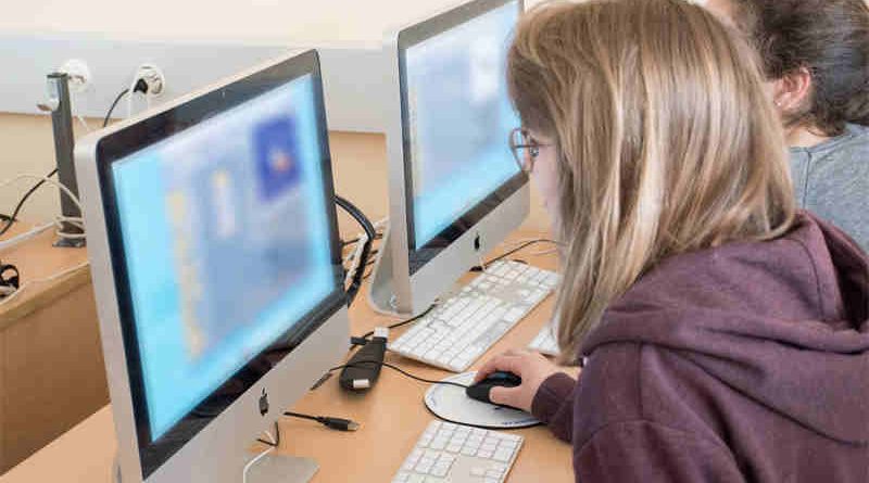 Two users browse websites on their computers (content blurred for privacy). Photo: ITU/A.Mhadhbi