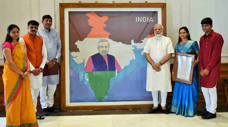 Narendra Modi being presented the artwork made with pearls by artist Khushboo Akash Davda, in New Delhi on June 15, 2017