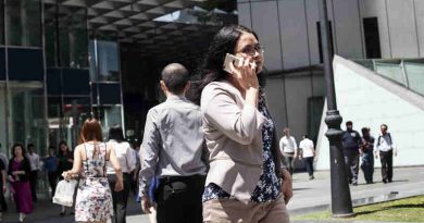 A woman speaks on the phone as she walks to work in Singapore. Photo: ILO/Giorgio Taraschi (Representational photo)