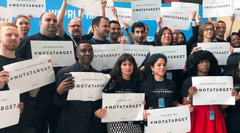 Staff stand together at United Nations Headquarters in New York to draw attention that civilians are #NotATarget. Photo: UN News/Paulina Carvajal