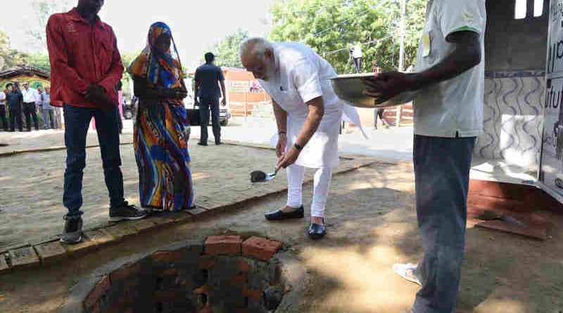 Narendra Modi doing shramdan for the construction of a twin pit toilet, at Village Shahanshahpur, Varanasi, Uttar Pradesh on September 23, 2017