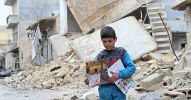 On 16 January 2017 in the Syrian Arab Republic, a child carries manuals distributed by UNICEF volunteers in the area following an informative session on identifying and reporting unexploded objects in Al- Sakhoor neighbourhood of East Aleppo.