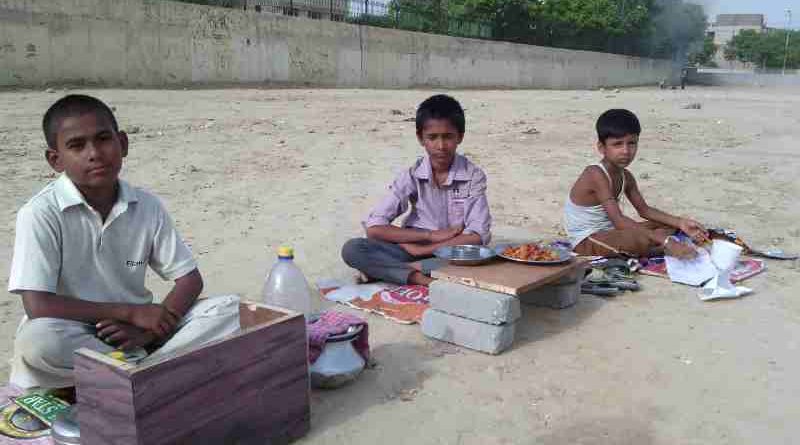 As school education is bad, young children are forced by parents to sell eatables outside a school building in New Delhi, India. Click the photo to know the details. Photo: Rakesh Raman / RMN News Service