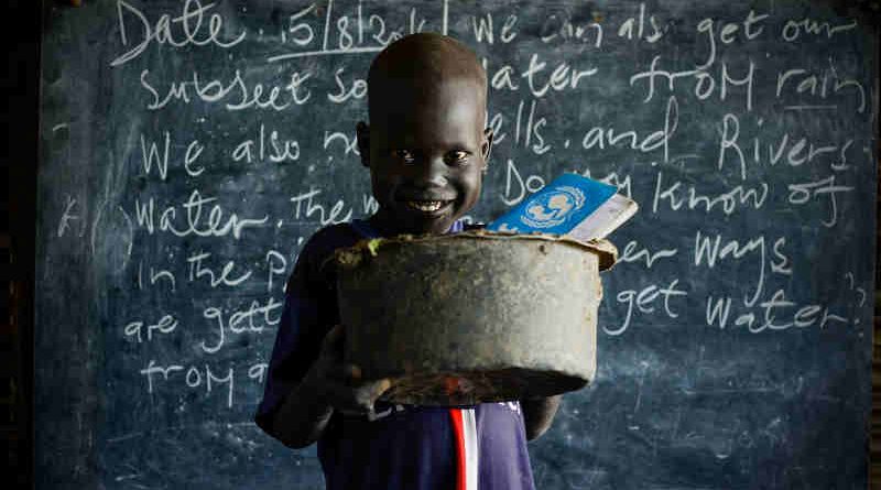 On 15 August 2016 in the Bentiu Protection of Civilians site (POC) in Unity State, Maet, 6, carries an old broken saucepan with a hole in it to school so he has something to sit on during class. Photo: UNICEF