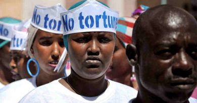 Singers wearing hats advocating "No Torture" line up before performing at a Human Rights Day event outside of Mogadishu Central Prison in Somalia. UN Photo/Tobin Jones