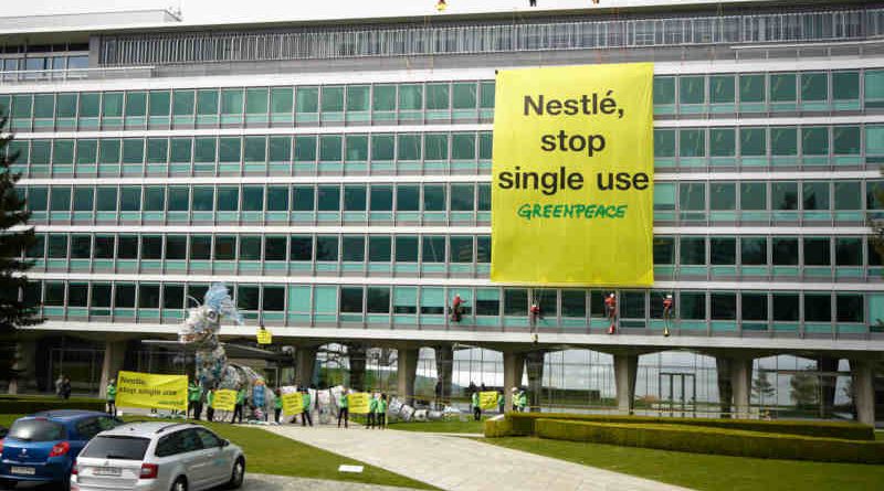 Plastic Monster Action at Nestlé Headquarters in Switzerland. Greenpeace activists deliver a 20-meter-long “plastic monster” covered in Nestlé branded plastic packaging to the company‘s global headquarters. Greenpeace is calling on Nestlé to end its reliance on single-use plastic. 16 April, 2019. Photo: Yukon Benner / Greenpeace