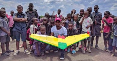 University student poses with school children at Kasungu Drone Corridor. A team of University of Malawi students, under the supervision of a team from Virginia Tech University, flew an autonomous 19 km simulated drug delivery flight in a drone. The drone was designed and built by the Malawian students. The flight testing occurred at the drone testing corridor in Kasungu. UNICEF through the Civil Aviation Authority (CAA) launched the air corridor to test potential humanitarian use of unmanned aerial vehicles (UAVs), also known as drones. The corridor is the first in Africa and one of the first globally. Drones have been used to test the feasibility of transporting laboratory samples for early infant HIV diagnosis, emergency medical supply delivery and vaccines. Photo: UNICEF