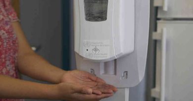 A health worker sanitizes her hands before putting on a mask. Photo: WHO (Representational Image)