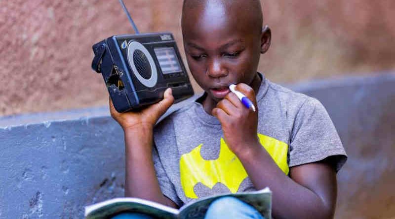 In Rwanda, a boy listens to a radio. Photo: UNICEF