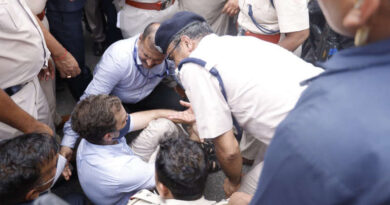 Congress leader Rahul Gandhi - surrounded by policemen - sitting on the road during a protest in New Delhi on July 26, 2022. Photo: Congress