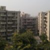 Aerial view of high-rise apartment complexes in New Delhi housing societies.